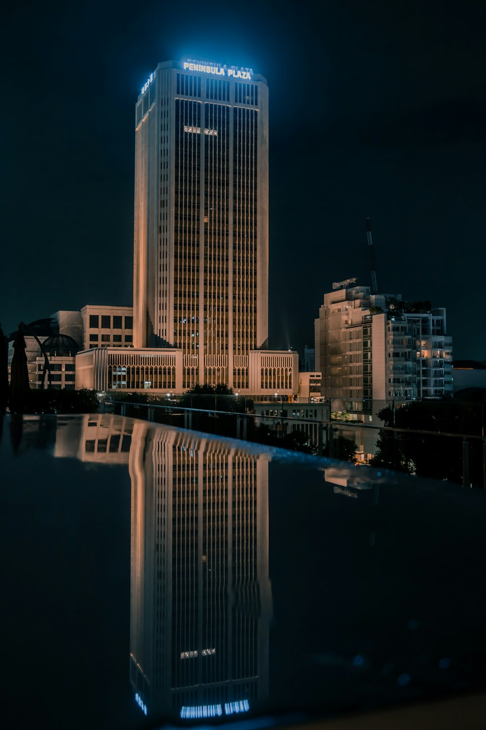 a tall building sitting next to a body of water