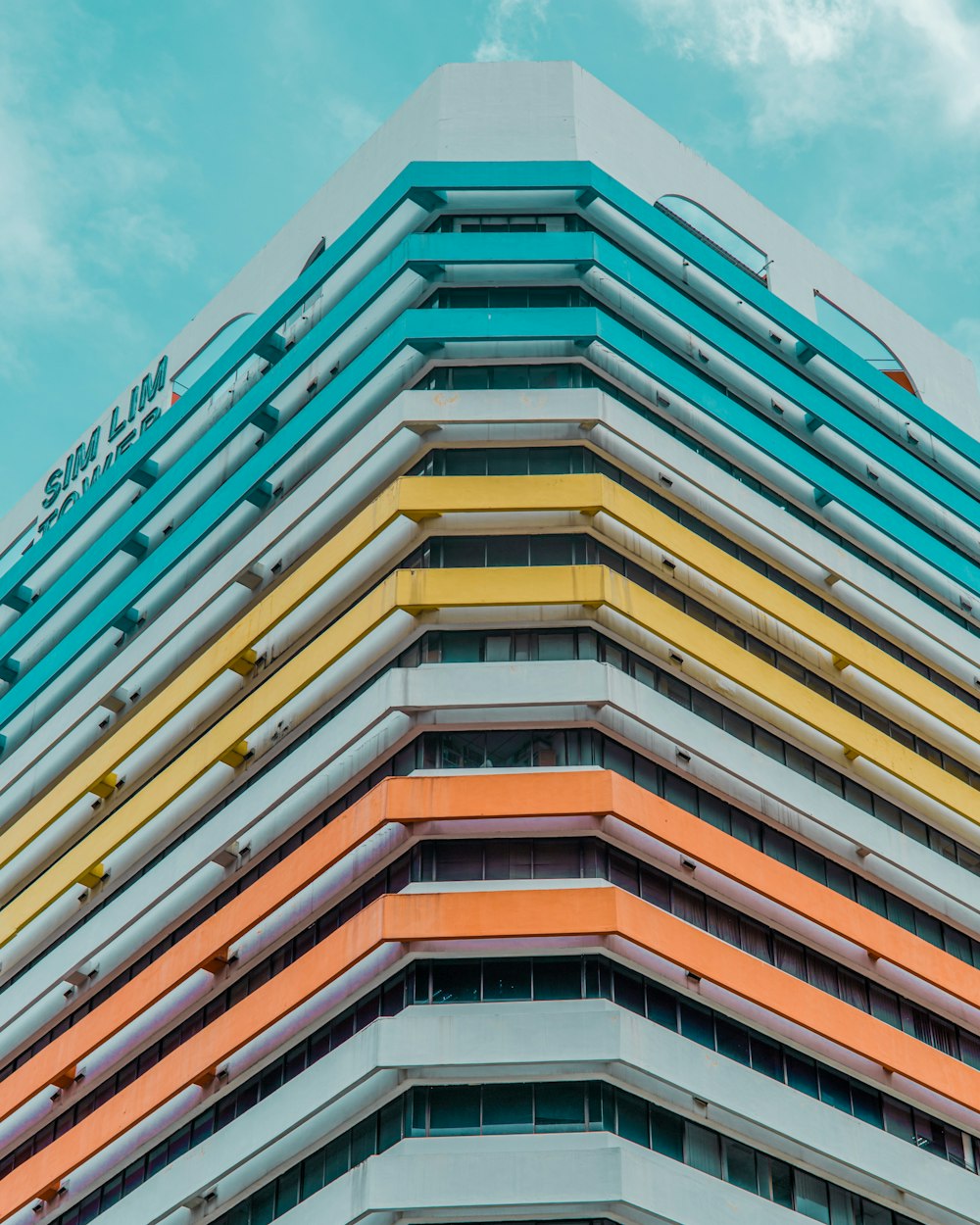 a multicolored building with a blue sky in the background