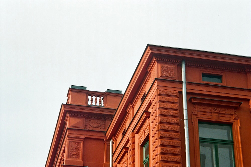 a red building with a clock on the top of it