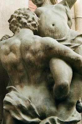 a statue of a man holding a woman