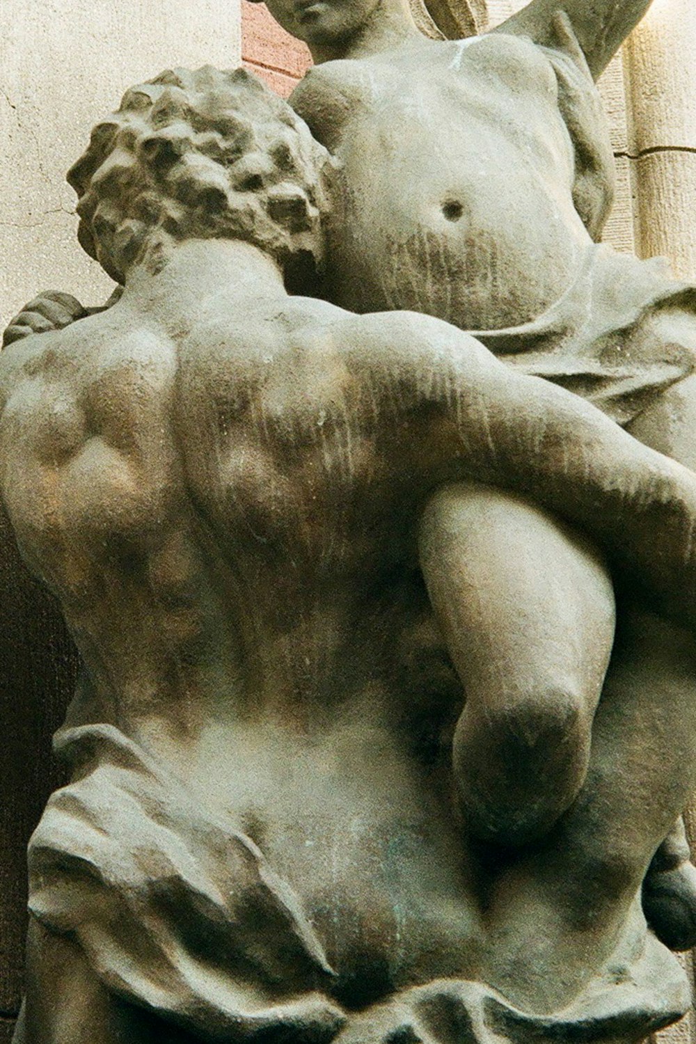 a statue of a man holding a woman