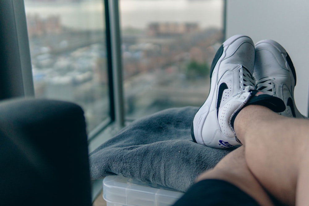 a person's feet resting on a window sill