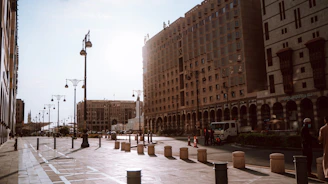 a city street lined with tall buildings next to tall buildings