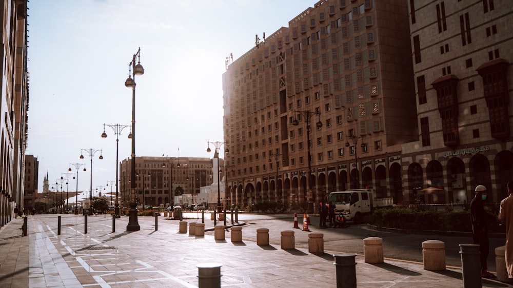 a city street lined with tall buildings next to tall buildings