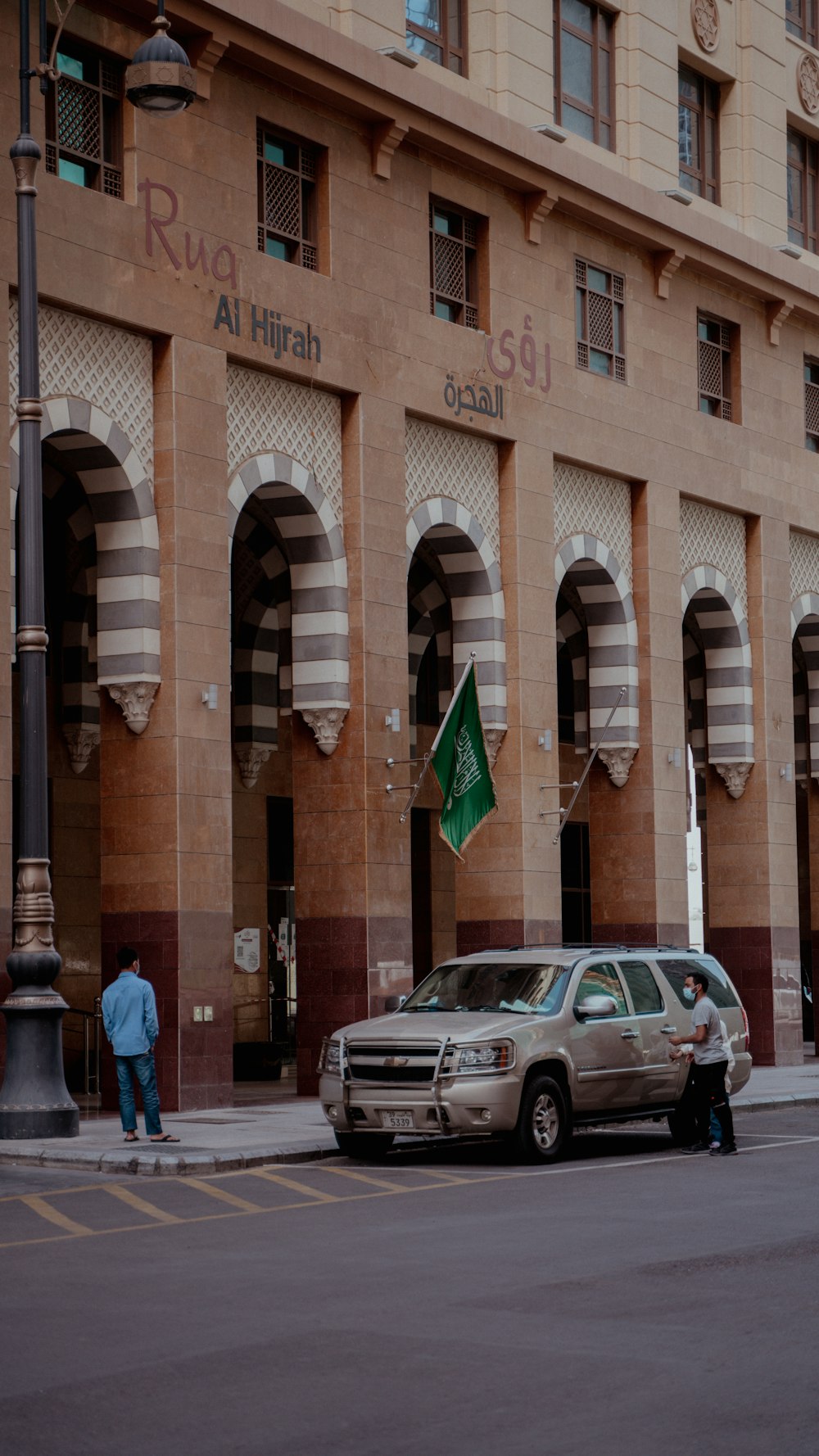 a car parked in front of a tall building