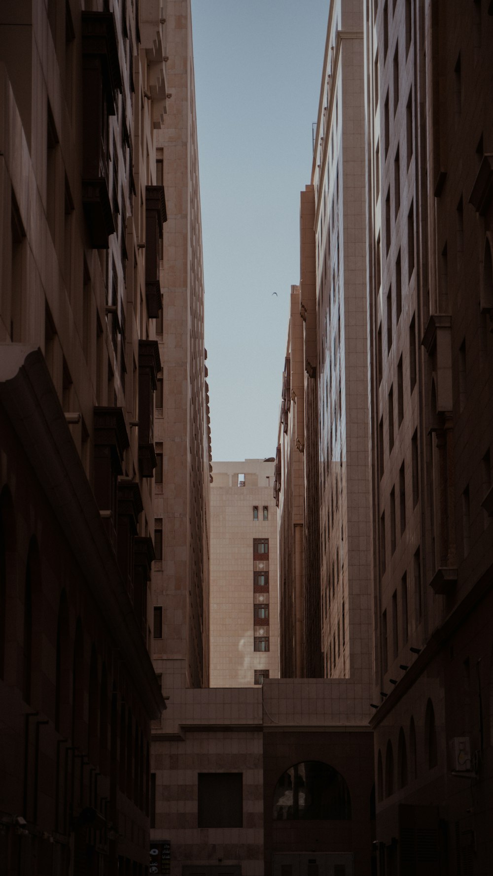 a narrow city street with tall buildings on both sides