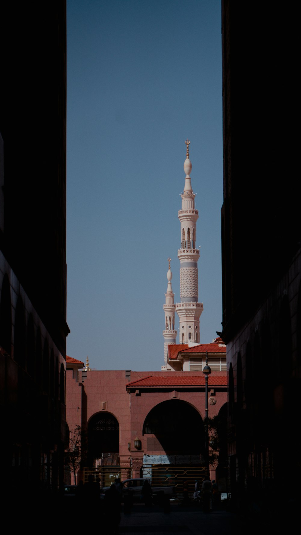 a view of a clock tower from between two buildings