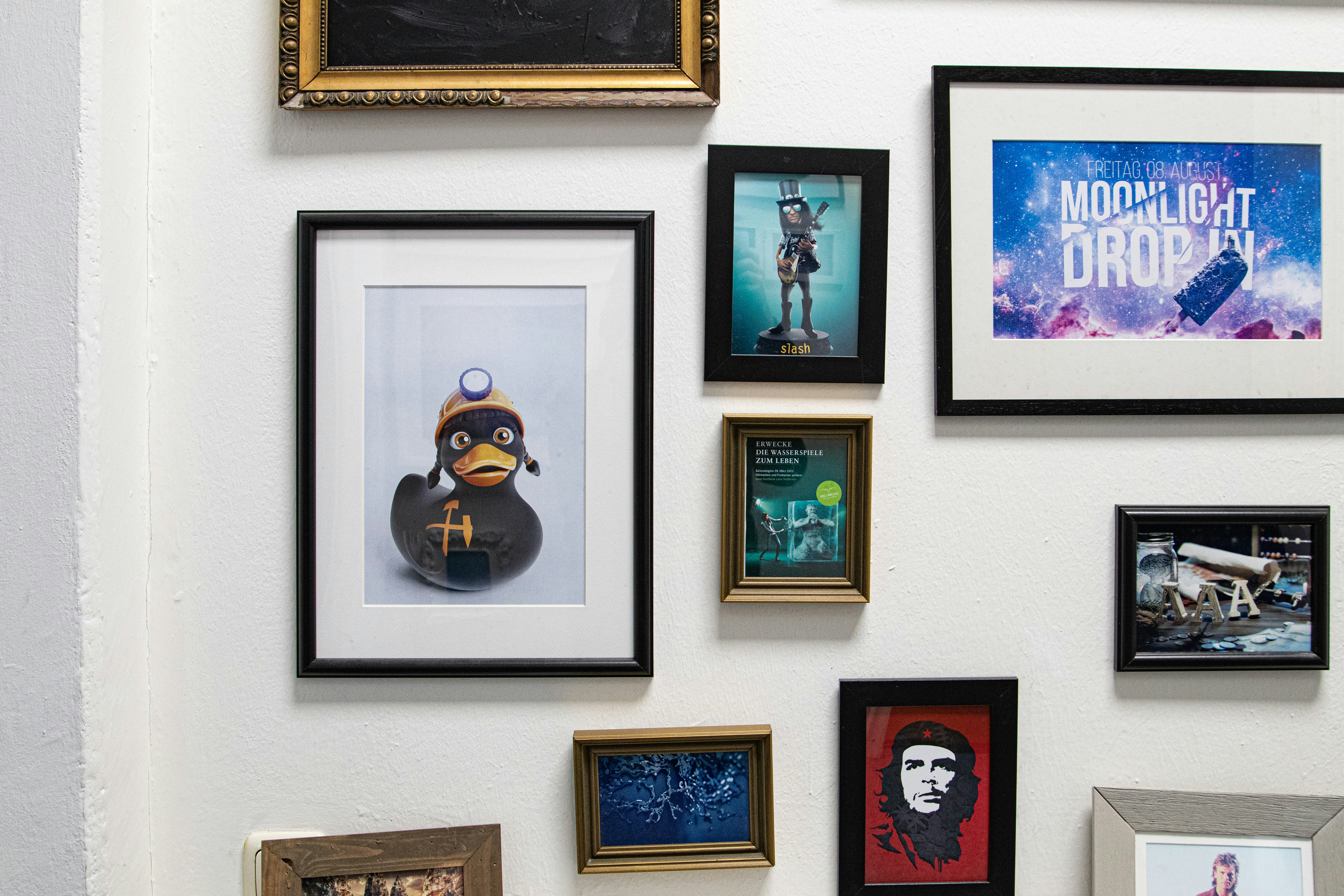 a bunch of framed pictures on a wall