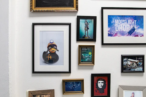 A wall densely covered edge to edge with framed pictures and artwork, a hall of frames