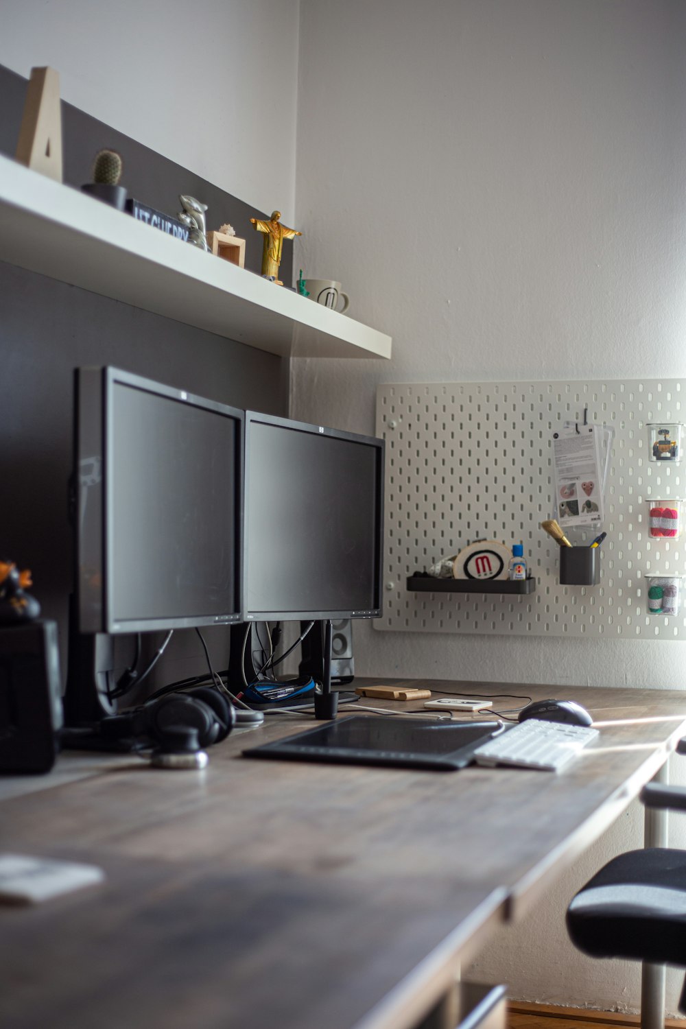 a desk with two monitors and a keyboard