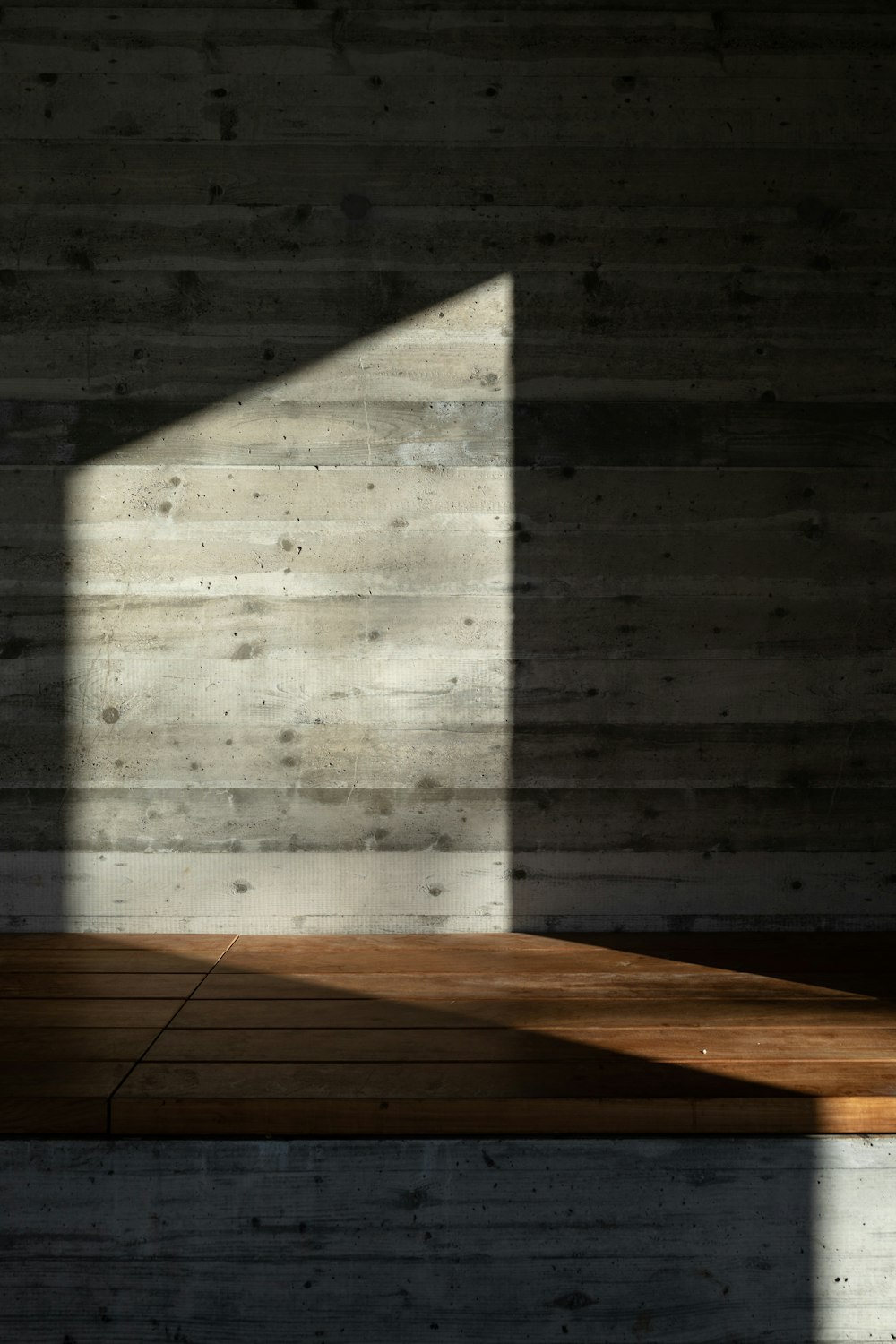 a room with a wooden floor and a window