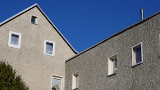 two windows on the side of a building