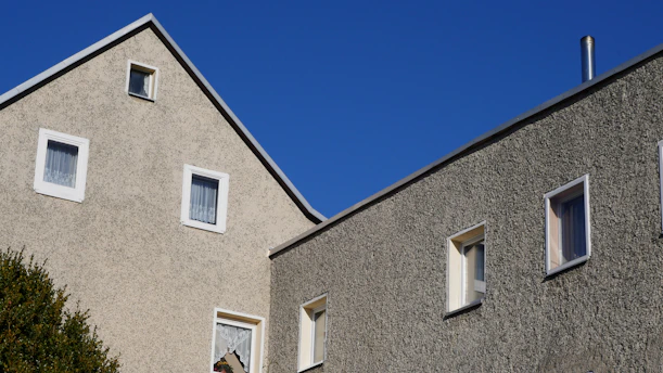 two windows on the side of a building