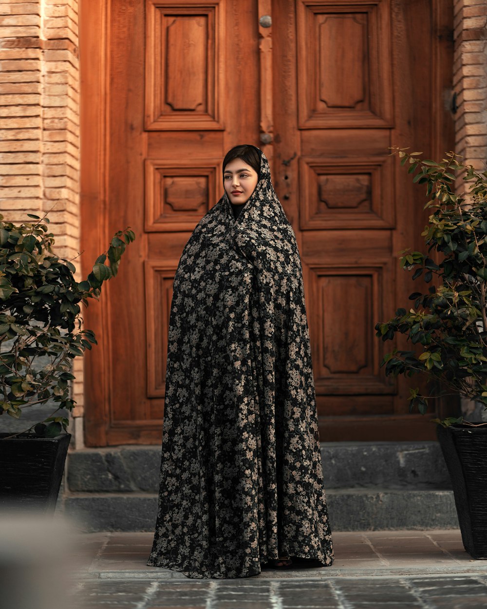 a woman standing in front of a wooden door