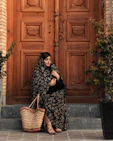 a woman sitting on the steps with a basket