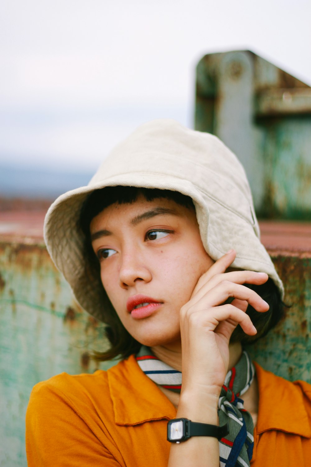 a boy wearing a hat talking on a cell phone