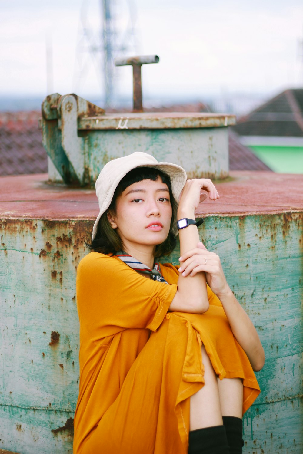 a woman in a yellow dress and a white hat