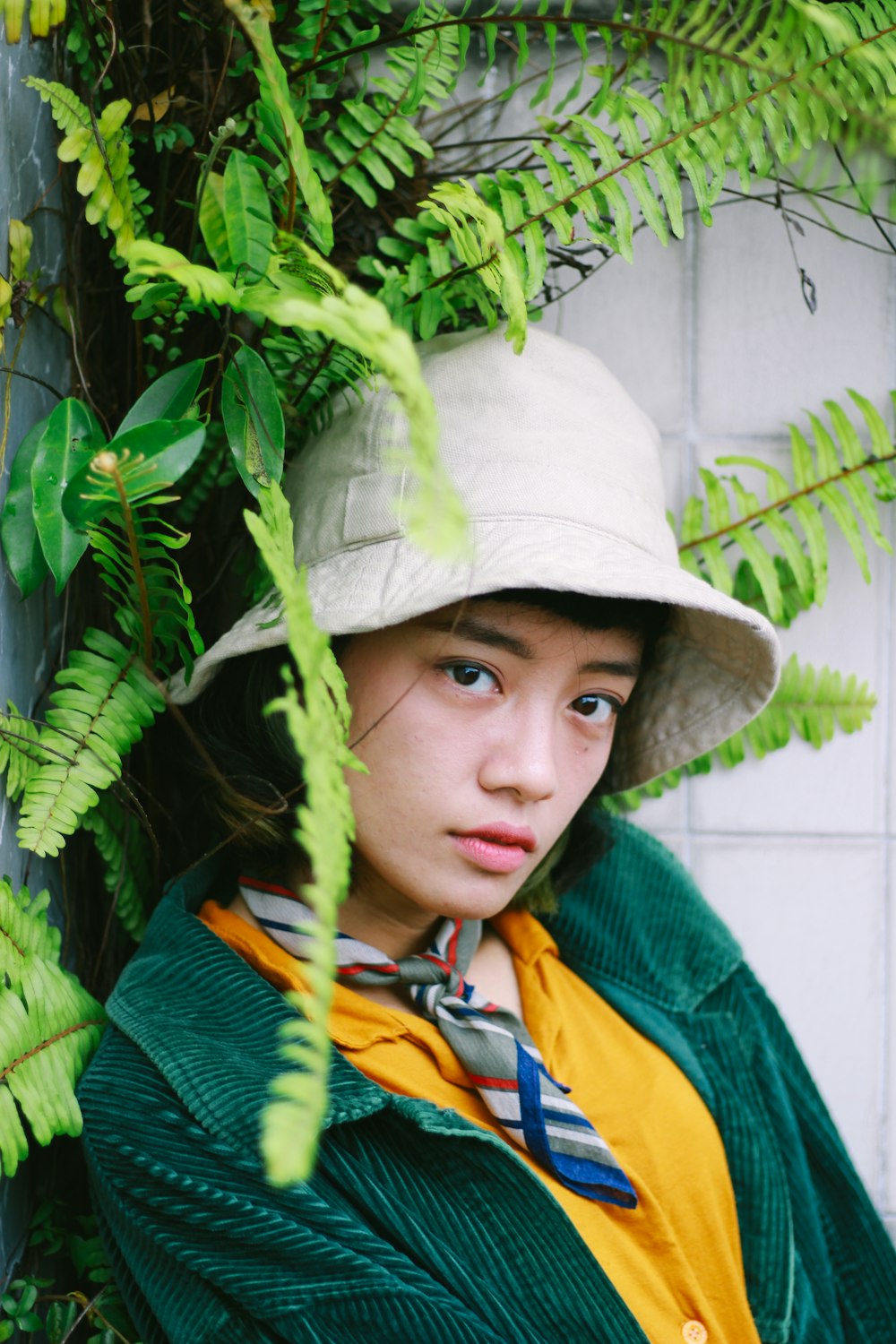 a woman wearing a hat and a green jacket