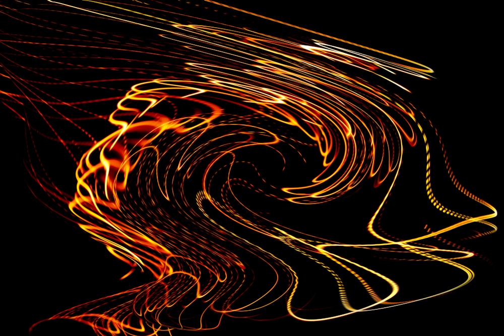 a black background with a swirl of orange and yellow lights