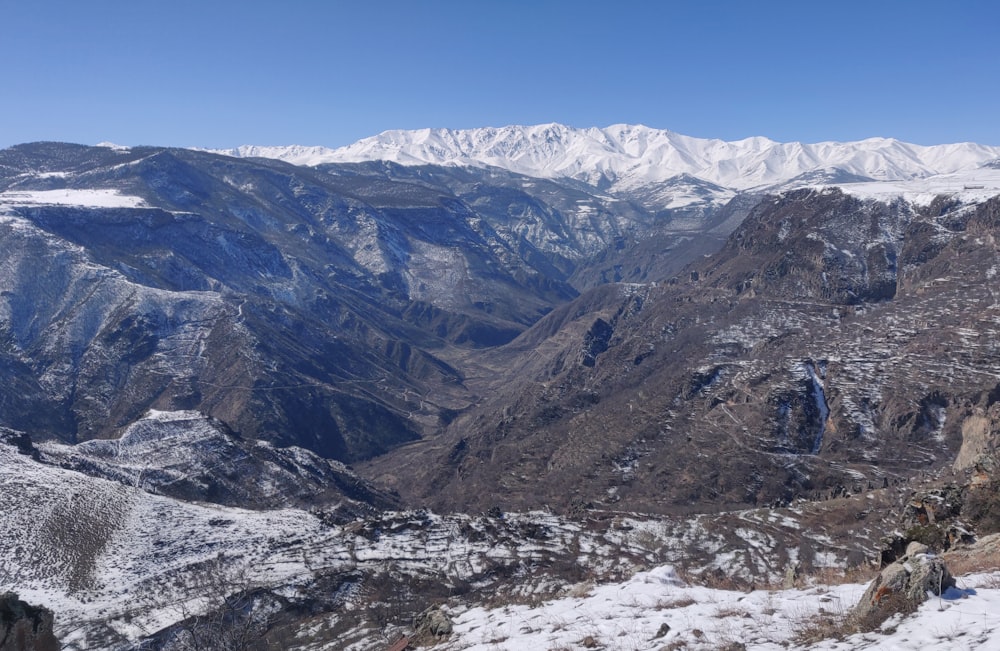 a view of a mountain range covered in snow