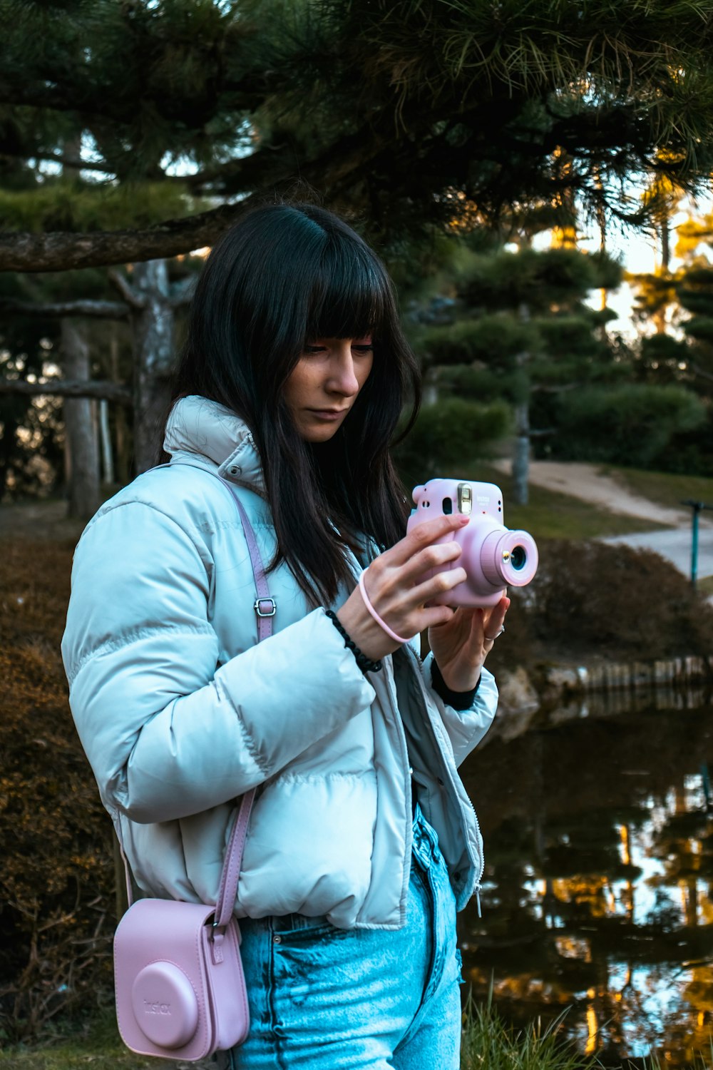 a woman holding a pink camera in her hands