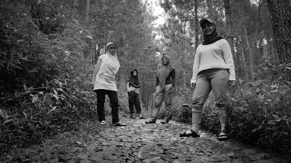 a group of people walking through a forest