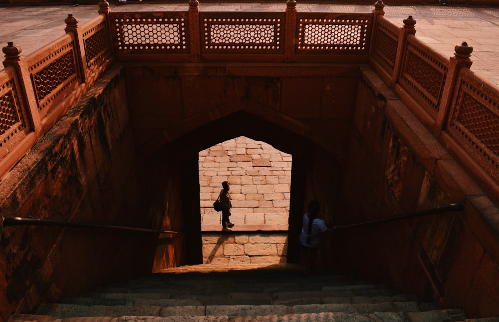 a couple of people that are walking up some stairs