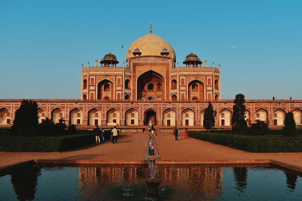 a large building with a fountain in front of it