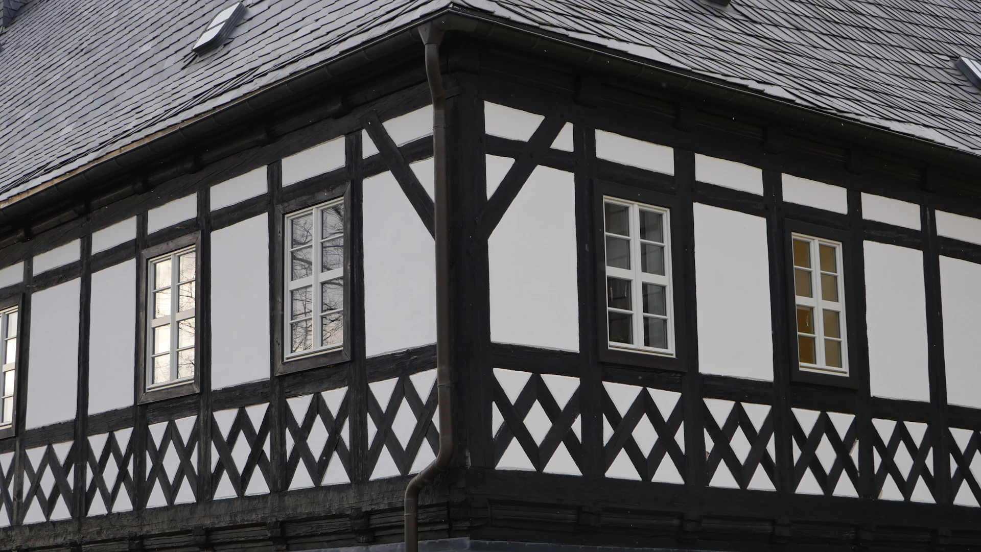 a black and white building with a clock on it's side