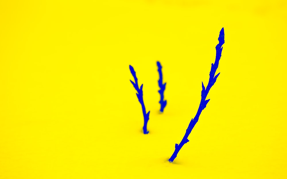 a yellow background with blue branches on it