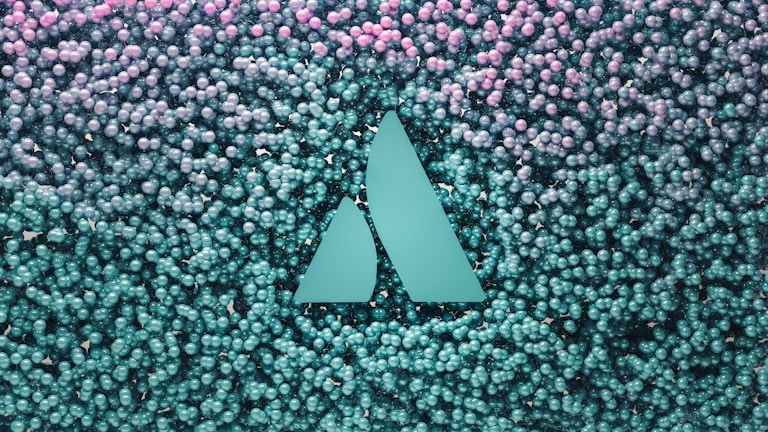 A geometric logo with two triangular shapes is embedded in a backdrop of numerous small spherical objects that transition from teal at the bottom to pink at the top.