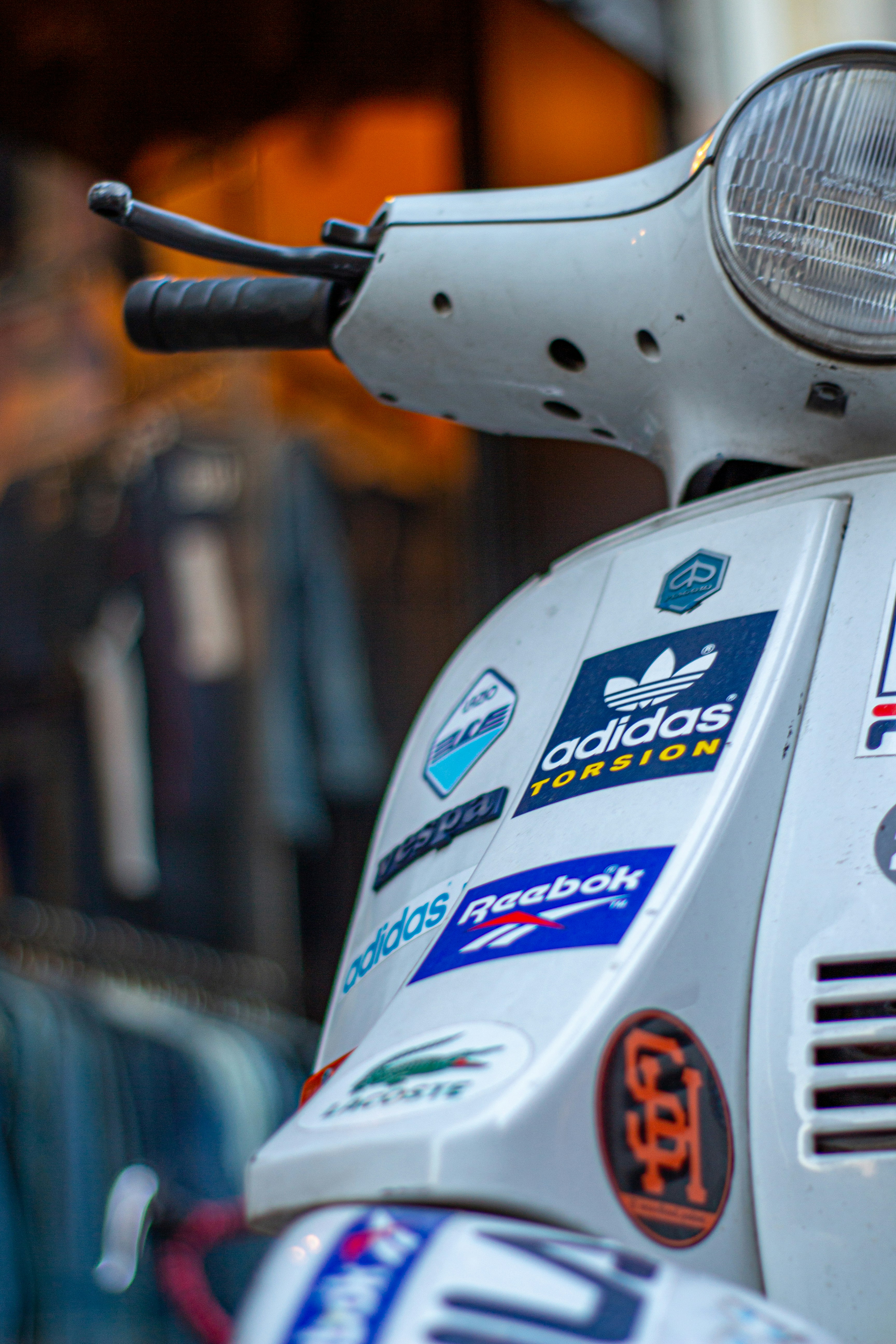 a close up of a moped with many stickers on it