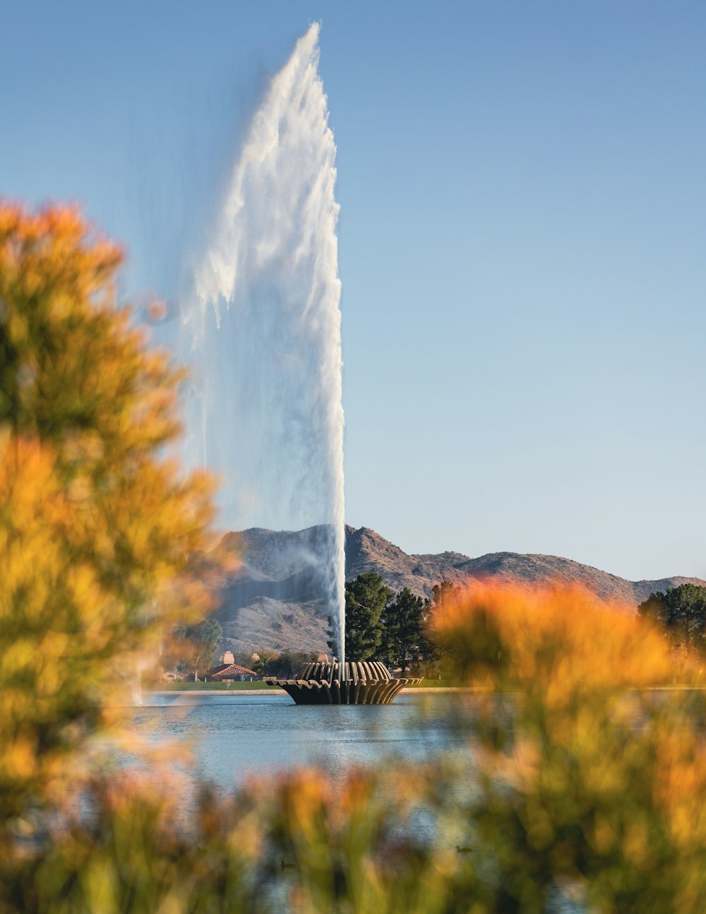 a large water spout spewing out of a lake