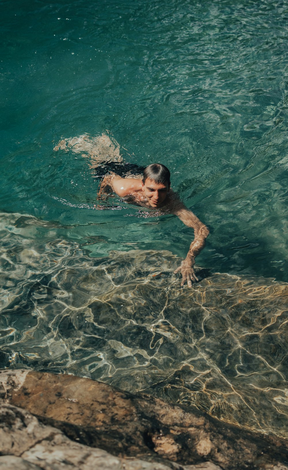 a man swimming in a pool of water