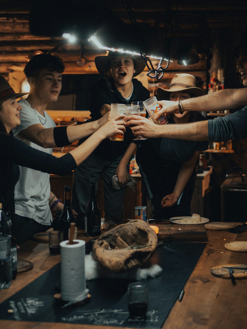 a group of people standing around a wooden table