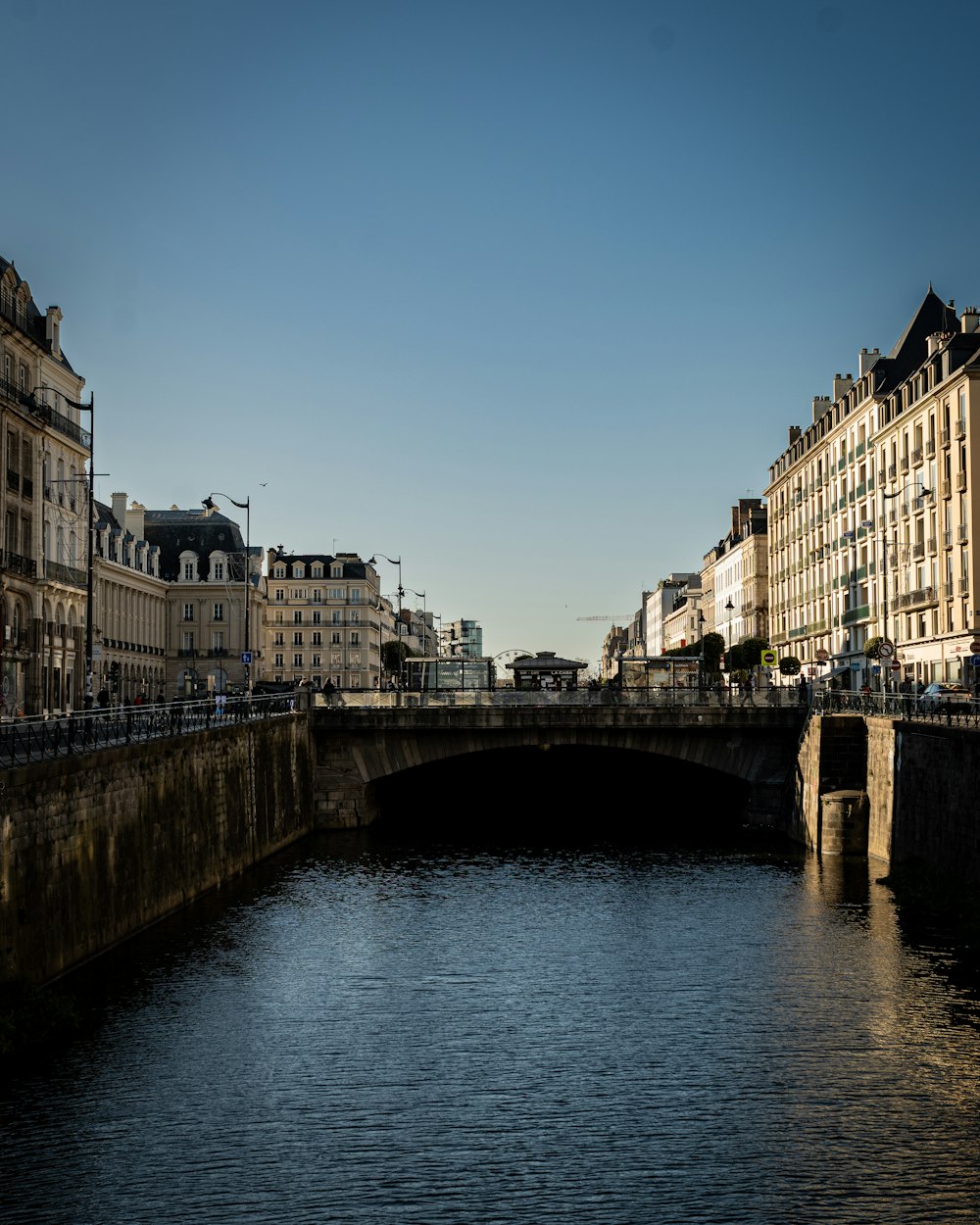 a river running through a city next to tall buildings