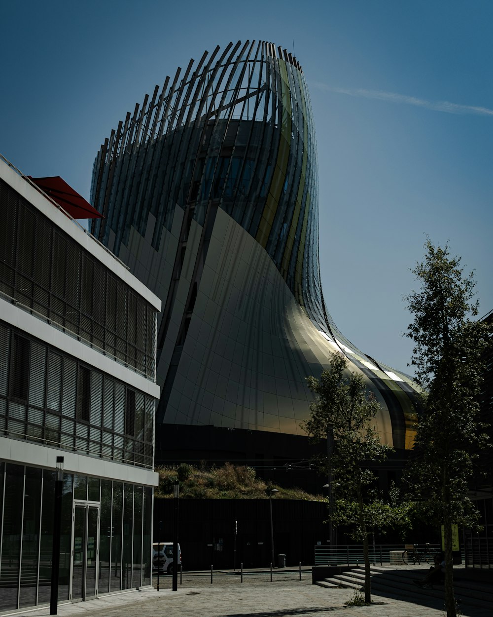 a modern building with a curved roof and glass windows