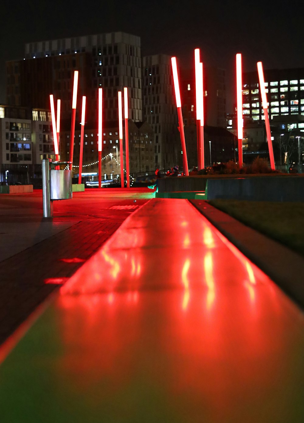 a red walkway in a city at night