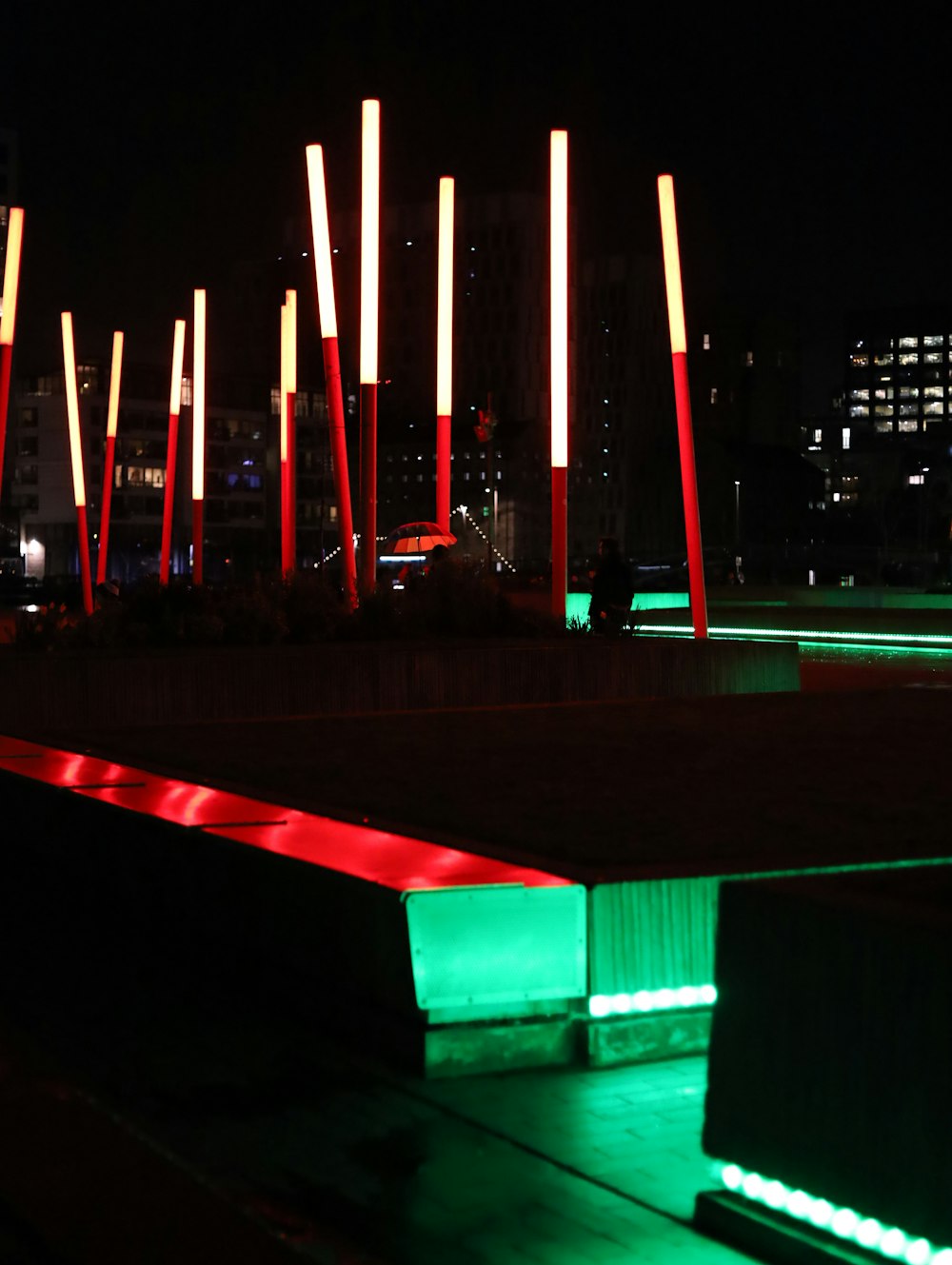 a group of red and green lights in the dark