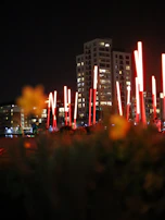 Night view of Goga Heights Smart City Katampe skyline with red accent lighting reflecting off buildings.