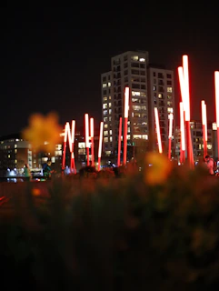 Night view of Goga Heights Smart City Katampe skyline with red accent lighting reflecting off buildings.