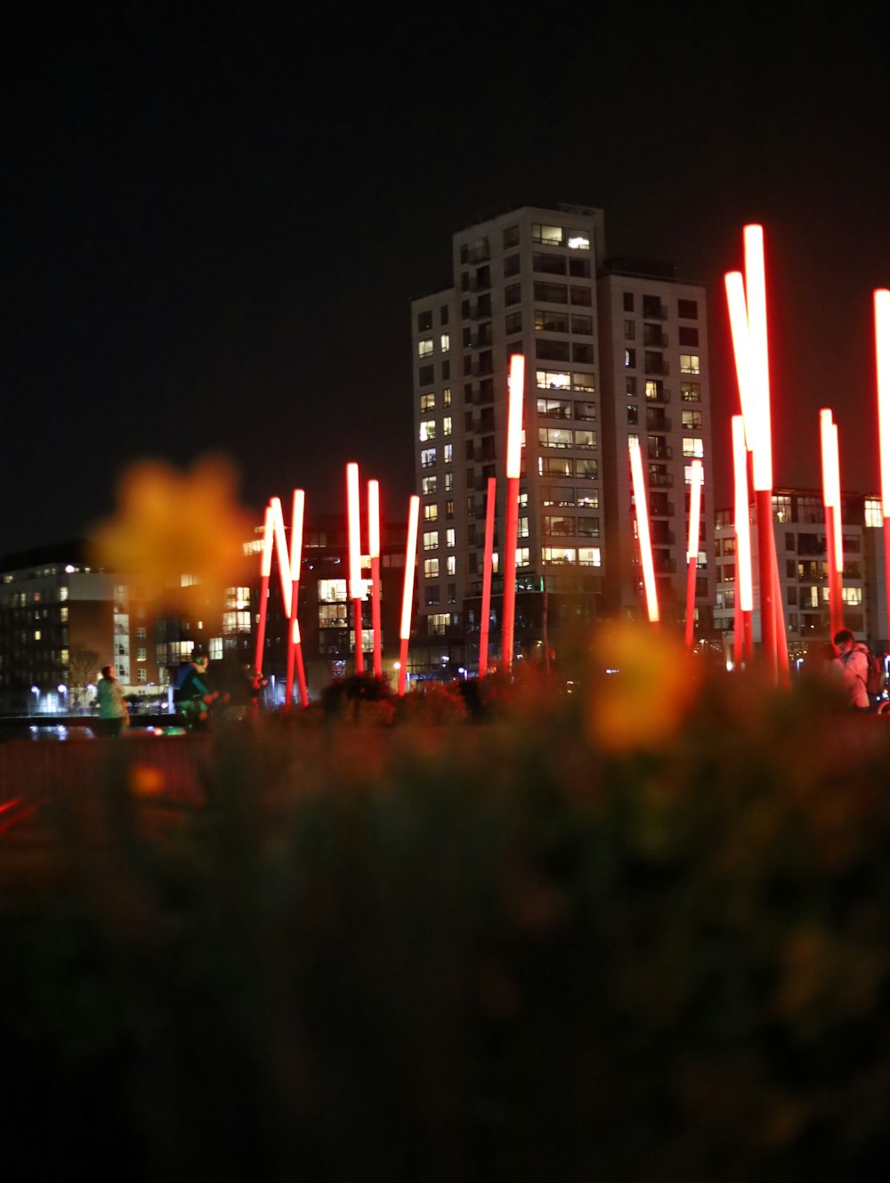 a view of a city at night with tall buildings in the background