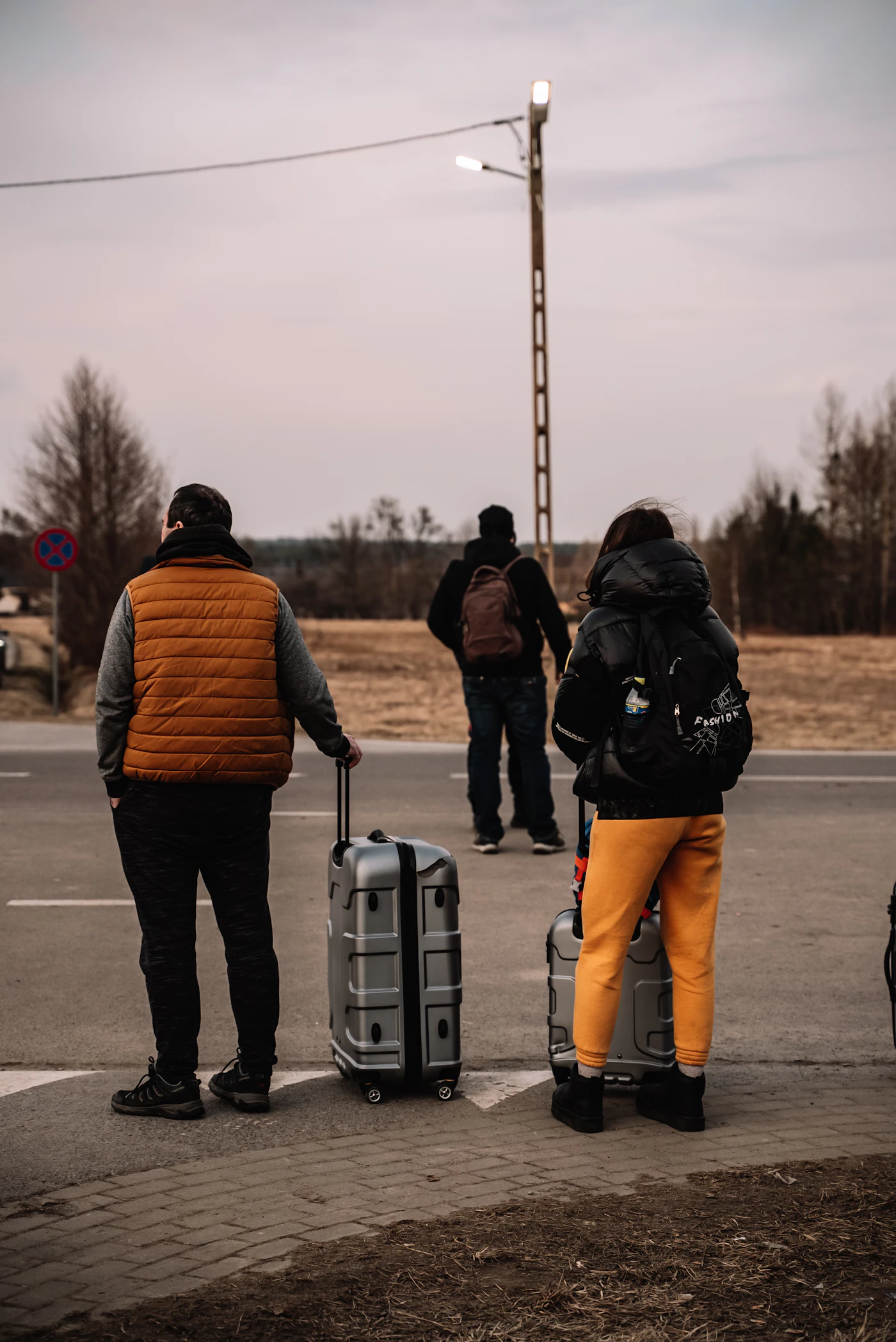 Displaced people waiting with their luggage