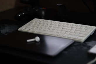 a computer keyboard sitting on top of a desk