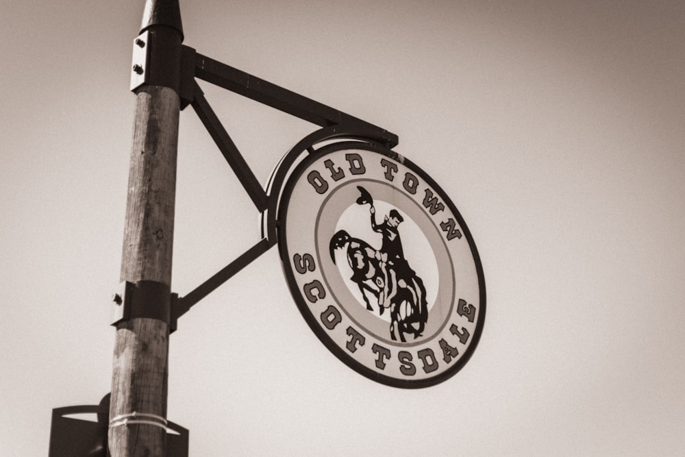 a black and white photo of a sign on a pole