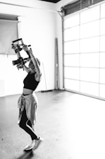 a woman doing a handstand in a garage