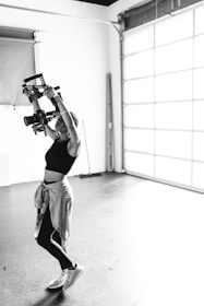a woman doing a handstand in a garage