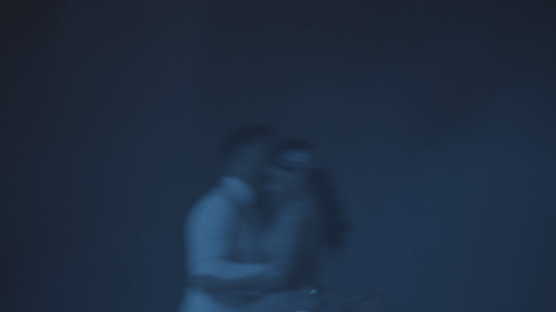 a blurry image of a woman holding a camera