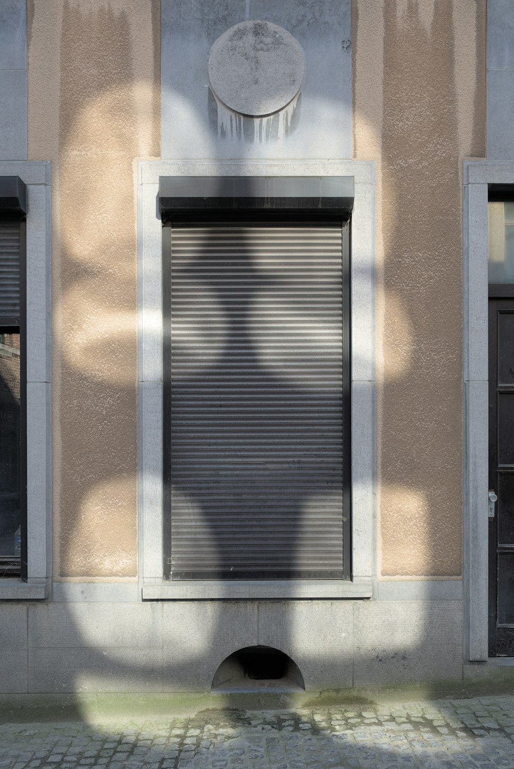 a shadow of a person on the side of a building
