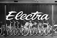 a black and white photo of many bicycles